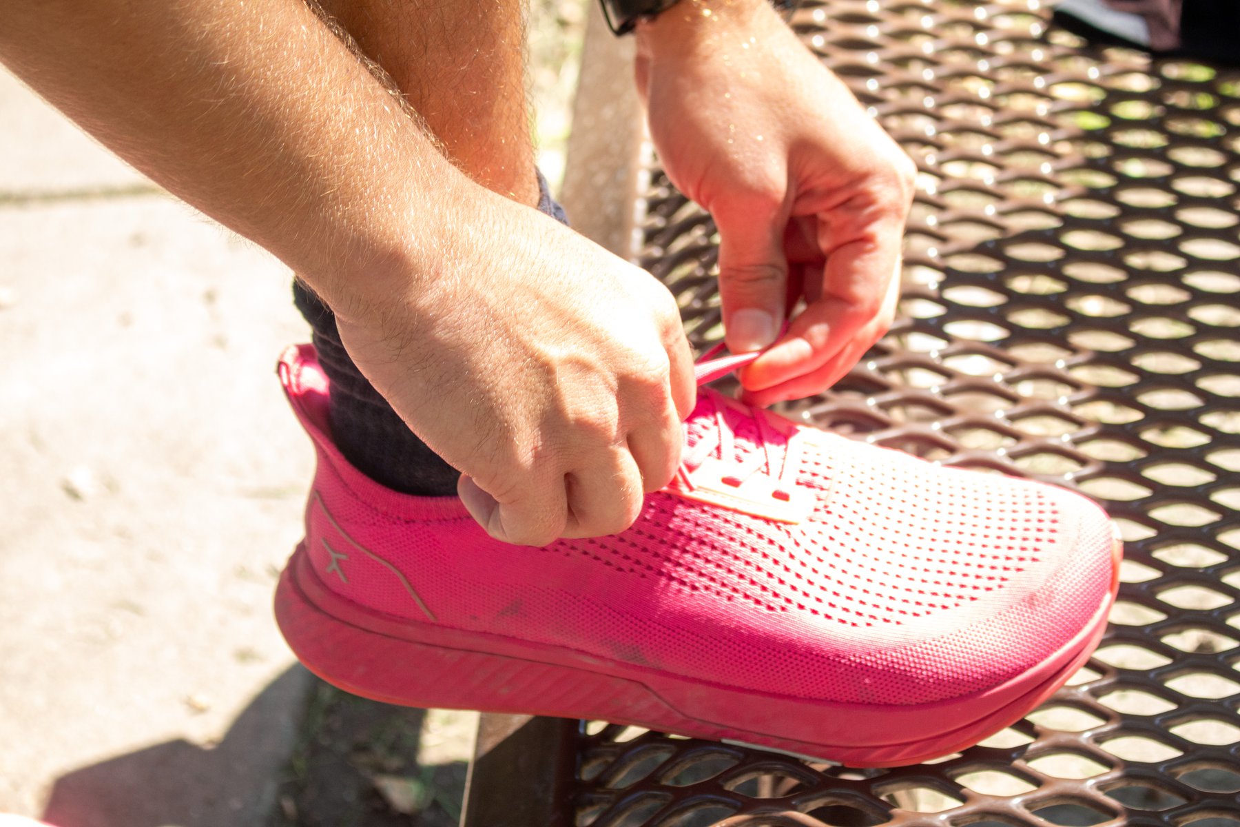 A close up shot of Tupper's bright pink sneakers