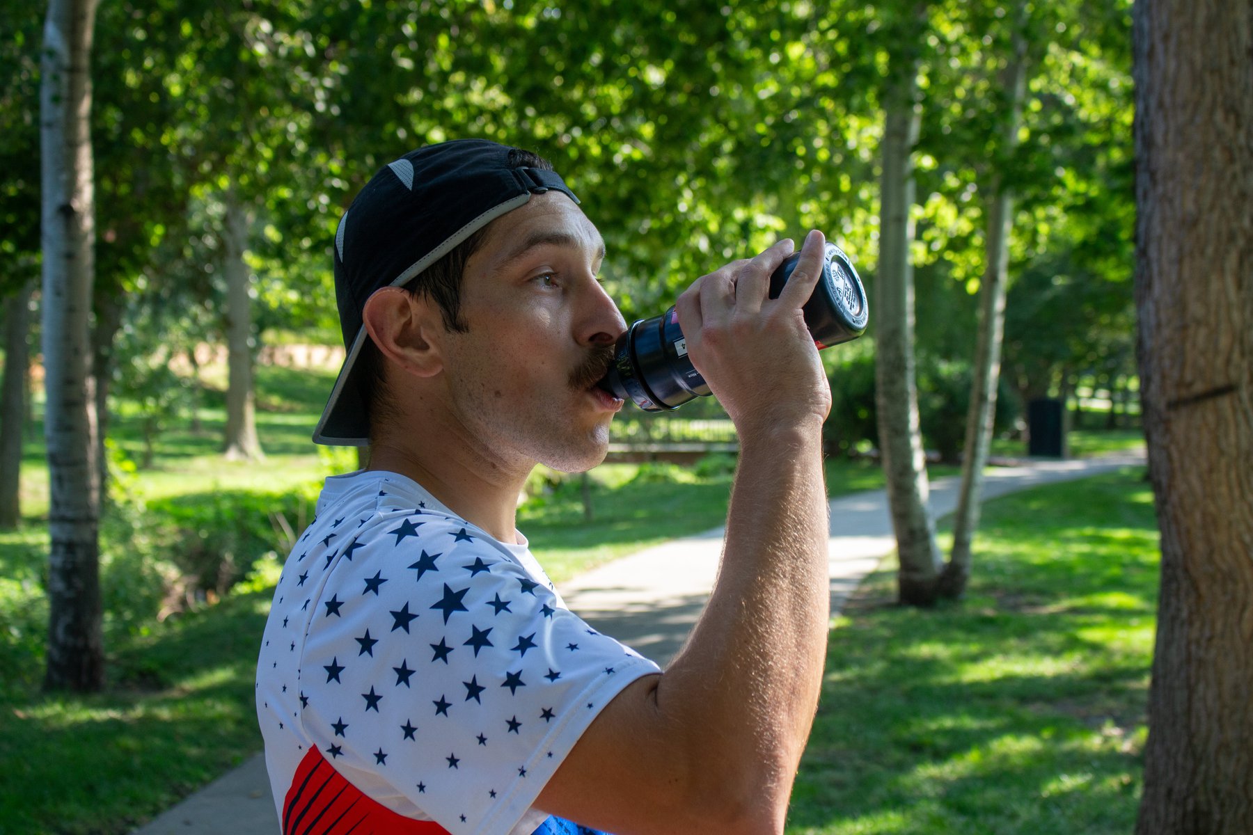 Tupper takes a swig of his water bottle in Blackhawk Park after training.