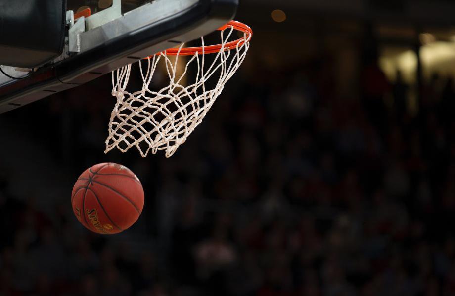 A basketball goes through a net